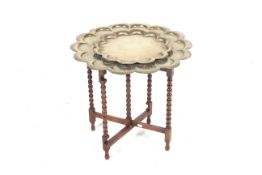 Two Islamic brass tray table tops and an oak folding stand.