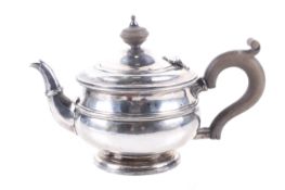 A bachelor's silver round teapot on foot.