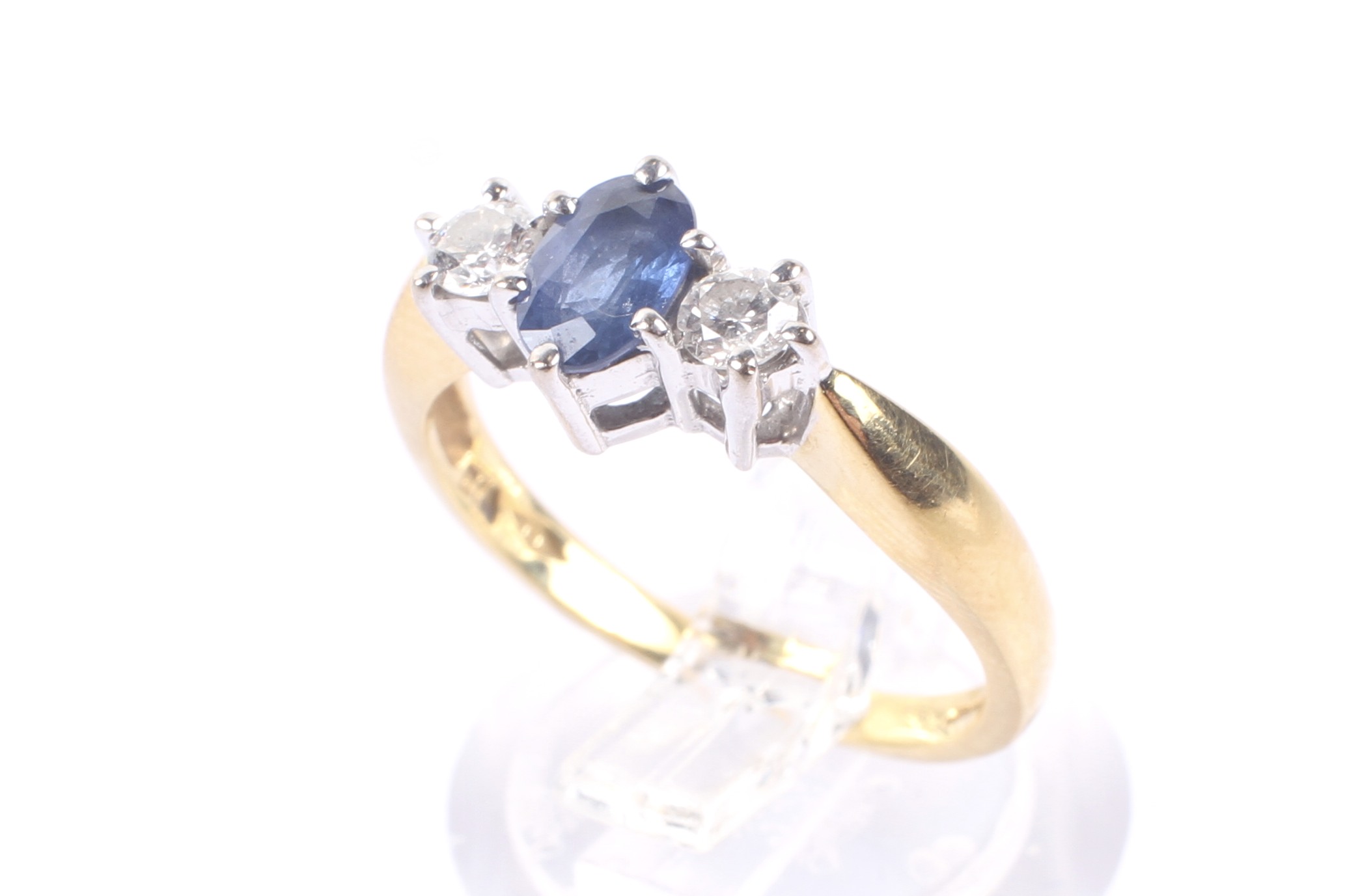 A modern 18ct gold, sapphire and diamond three stone ring.