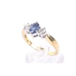 A modern 18ct gold, sapphire and diamond three stone ring.