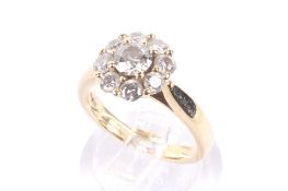 A modern 18ct gold and diamond cluster ring. The nine round brilliants approx. 1.