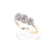 A vintage 18ct gold and diamond three stone illusion ring.