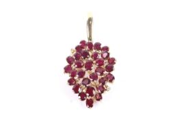 A vintage ruby and diamond pendant in the form of a stylised leaf-cluster drop.