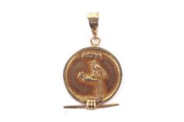 A vintage Egyptian yellow metal pendant.