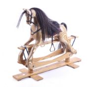 A 20th century model of a rocking horse.Oak base to a carved plywood body.