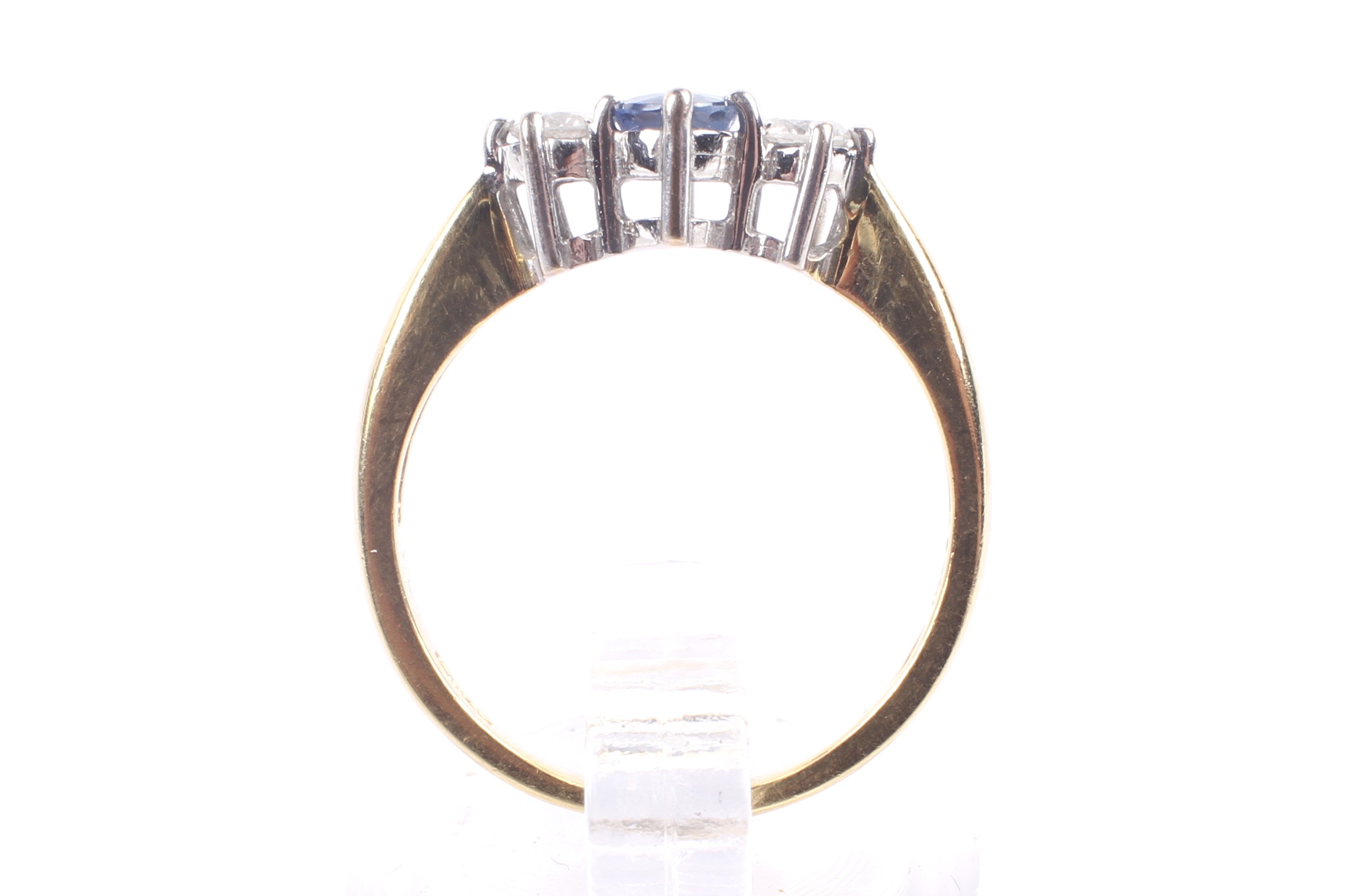 A modern 18ct gold, sapphire and diamond three stone ring. - Image 3 of 4