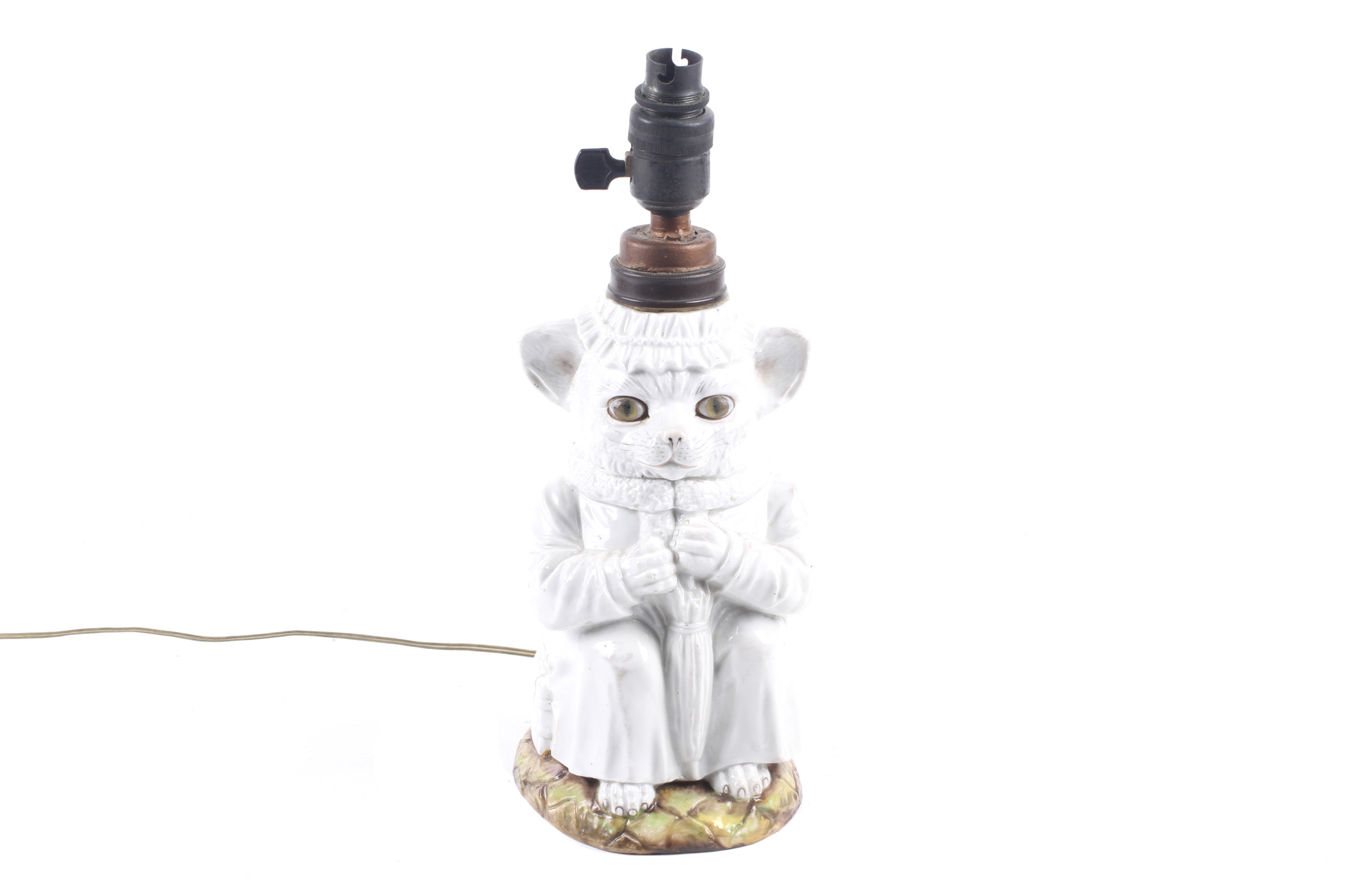 A Victorian white glazed ceramic nanny cat nursery lamp.