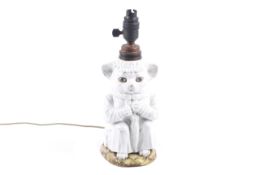 A Victorian white glazed ceramic nanny cat nursery lamp.