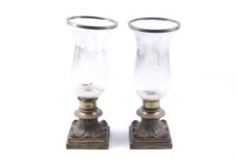 A pair of Victorian candle lamps. With glass shades, mounted on brass stepped square bases.