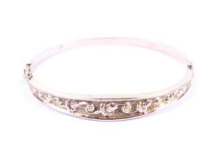 An early 20th century 9ct rose gold hinged bangle.