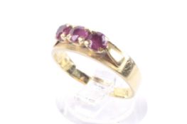 A vintage ruby three stone ring. The round mixed-cut stones approx. 3.