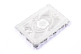 A Victorian silver rectangular card case, Of shaped outline and engraved with flowers,