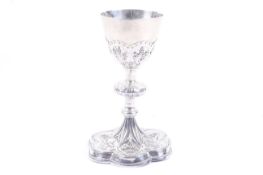 A 19th century French silver chalice with a round bowl with applied flowers in strapwork panels,