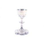 A 19th century French silver chalice with a round bowl with applied flowers in strapwork panels,