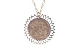 A sovereign, 1911, loosely mounted in a later 9ct gold pendant mount. On a belcher chain, 16.