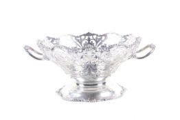 A silver round fruit bowl on foot.