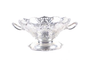 A silver round fruit bowl on foot.