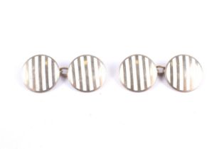 A pair of early 20th century gold and white enamel round twin-panel cufflinks.