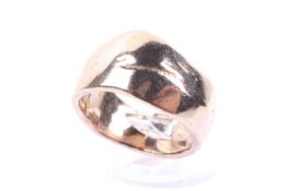 A 14ct gold shaped and hammered broad band ring.