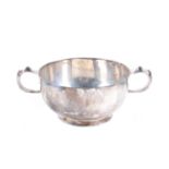 A silver porringer shaped sugar bowl.