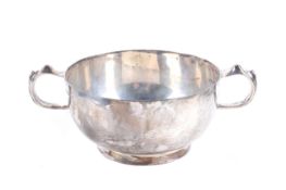 A silver porringer shaped sugar bowl.