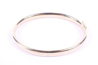 A vintage Italian 18ct gold hollow D-section hinged bangle. Import hallmarks for Edinburgh 1998, 14.