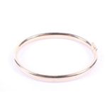 A vintage Italian 18ct gold hollow D-section hinged bangle. Import hallmarks for Edinburgh 1998, 14.