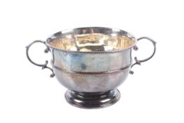 A silver round sugar bowl.