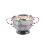 A silver round sugar bowl.