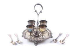 A Victorian silver shaped-round egg cruet with four egg cups.