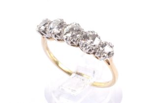 A mid 20th century gold and diamond five stone ring. The graduated old-cut stones approx. 1.