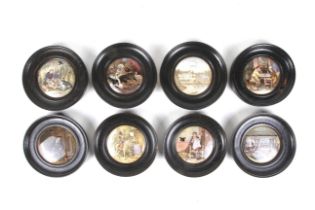 Eight ebonised oak framed Prattware pot lids.