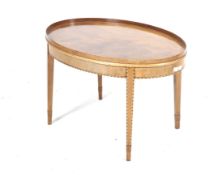 A Sheraton Revival 20th century blonde mahogany inlaid oval coffee table standing on on square