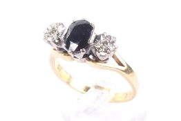 A vintage 18ct gold, sapphire and diamond three stone ring.
