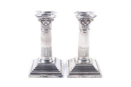 A pair of late Victorian square based candlesticks.