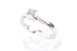 A modern platinum and diamond solitaire ring. The princess-cut stone approx. 0.