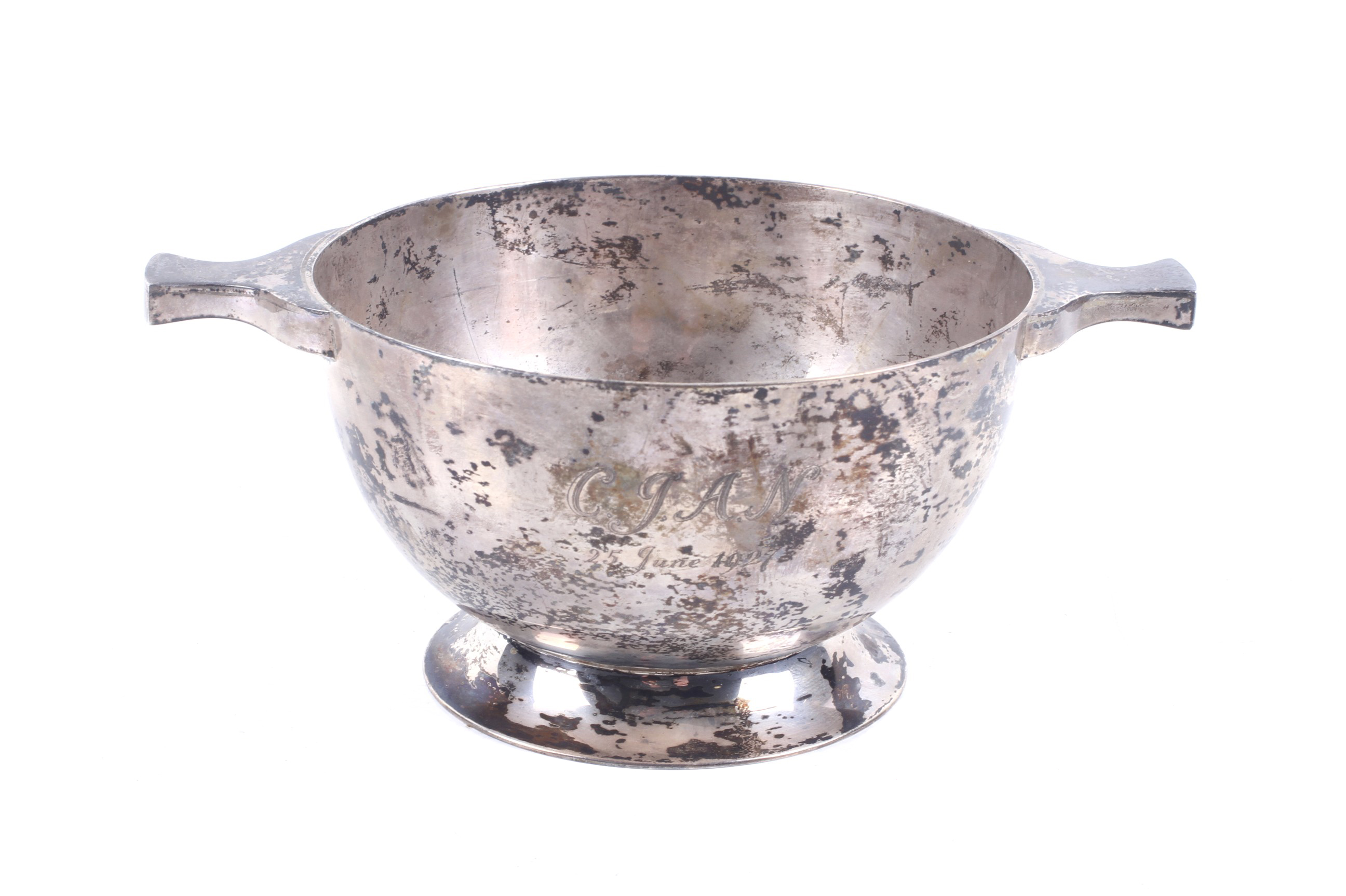 A silver round sugar bowl in the form of a quaich.