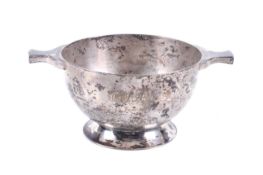 A silver round sugar bowl in the form of a quaich.