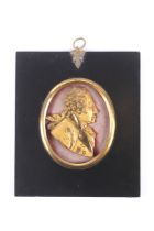 A gilt metal George III miniature profile portrait.