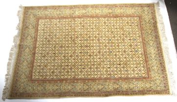 A yellow ground rug with flower decoration. Surrounded by a geometric border and tassles.