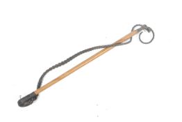 A Malacca Riding crop. With a brass handle and braided leather tail, L75cm.
