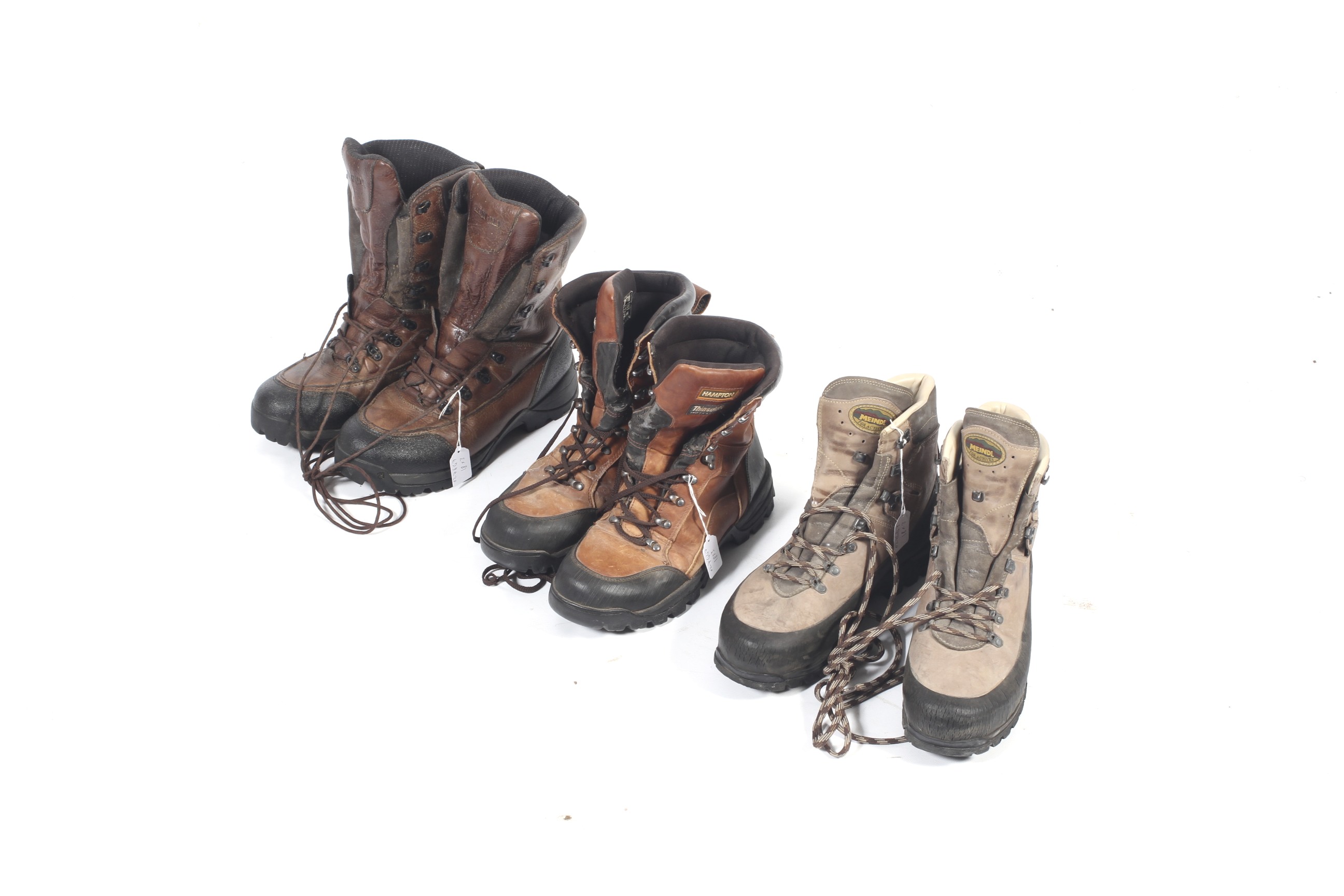 Three pairs of outdoor walking boots.