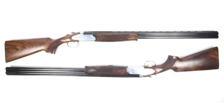 A pair of Lincoln Premium 12 gauge and 20 gauge over and under shotguns in a fitted case.