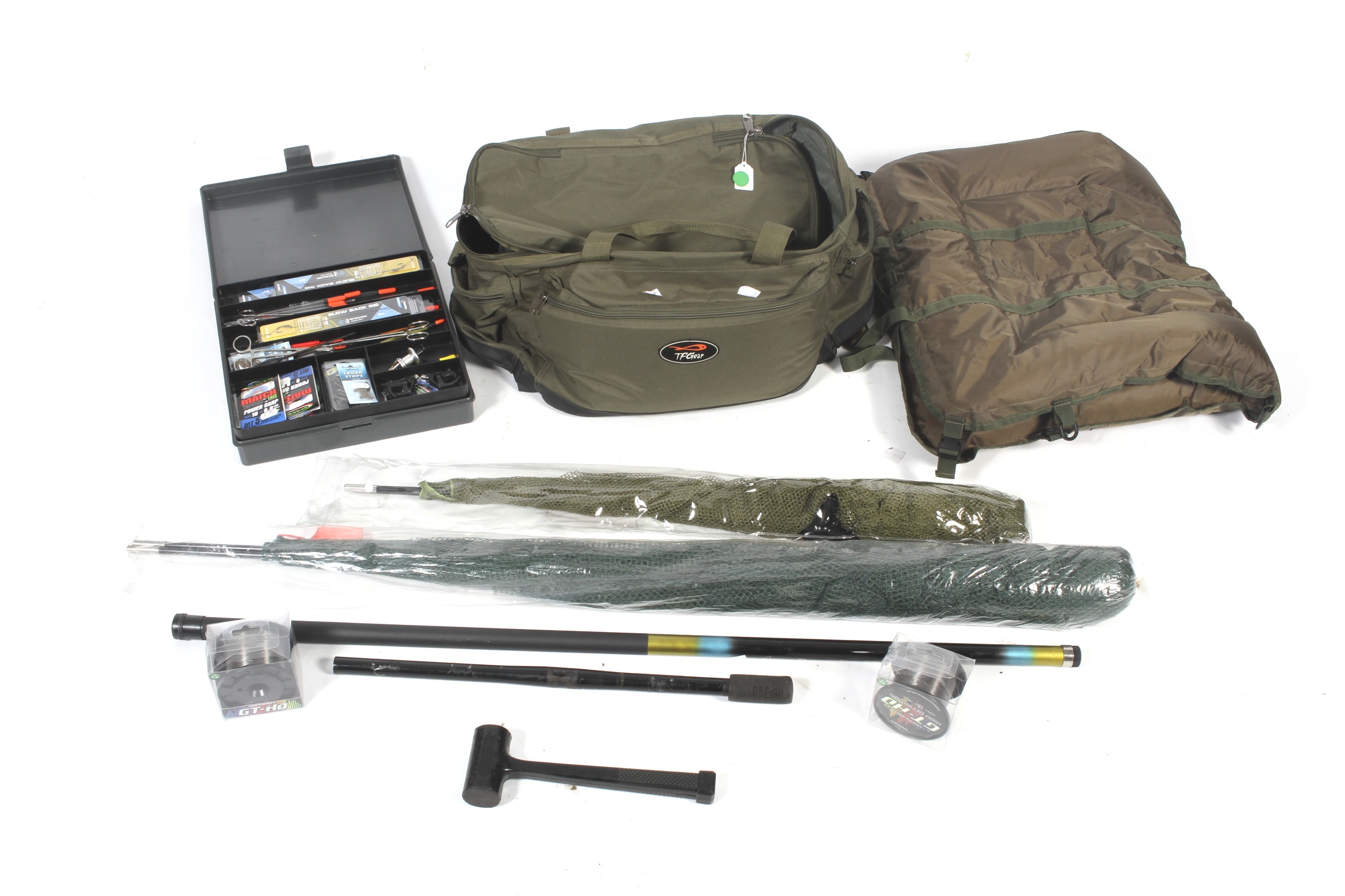 A carp fishing tackle bag containing various paraphernalia.