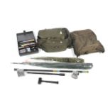 A carp fishing tackle bag containing various paraphernalia.