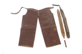 A pair of leather riding chaps and two cartridge belts. Chaps L100cm.
