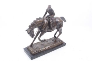 A bronze sculpture of a horse and rider.