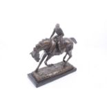 A bronze sculpture of a horse and rider.