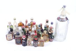 A Schweppers Soda syphon and alcohol miniatures. Including liqueur, vodka, etc.