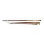Three vintage split cane fishing rods.